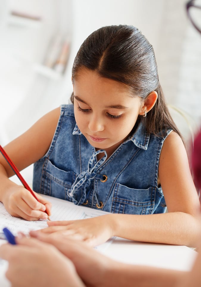 student writing on paper