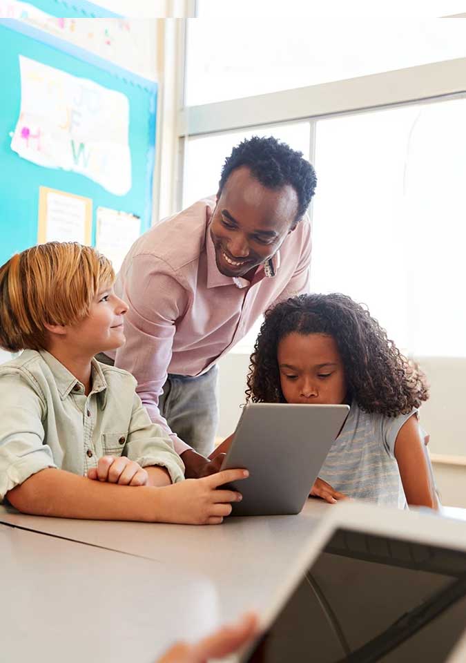 male teacher helping students