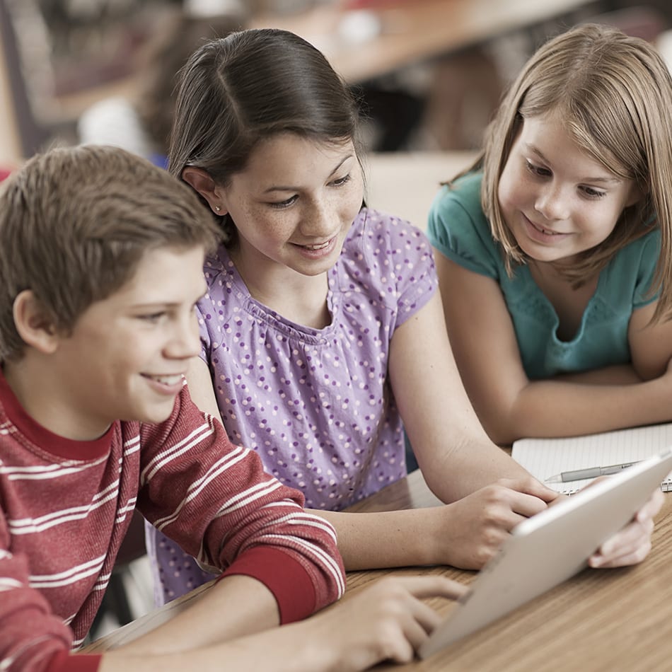 young students looking at tablet