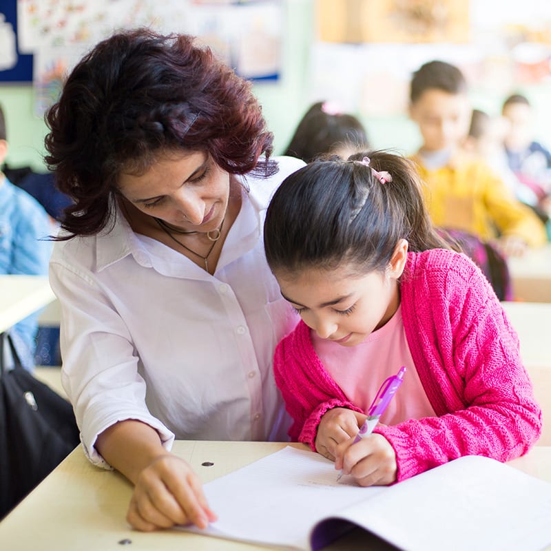 teacher helping student with work